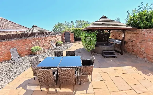 Stunning private courtyard with hot tub at Hawthorne Cottage, Mill Farm Leisure