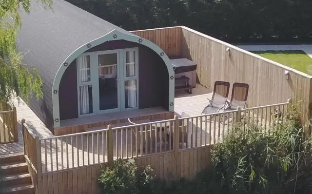 Cedar Lodge at Mill Farm Leisure with a stunning wooden deck area with hot tub, overlooking the lake.
